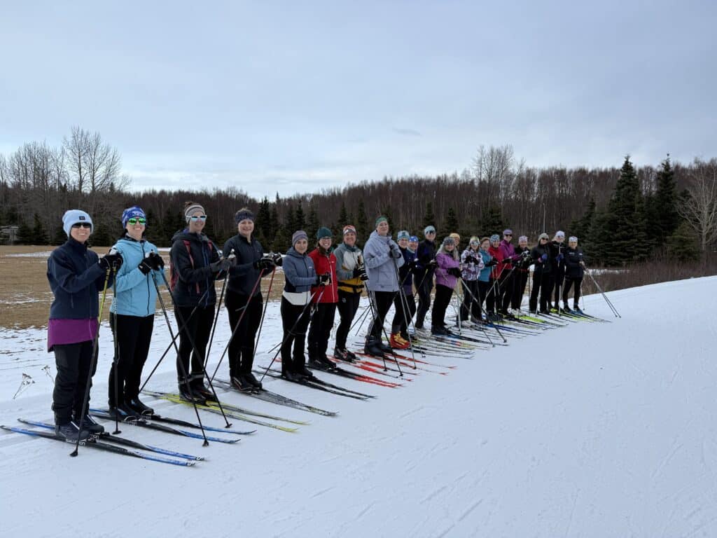 APU Nordic Ski Center's Women’s group, led by the program's coach, Sarah Miller 